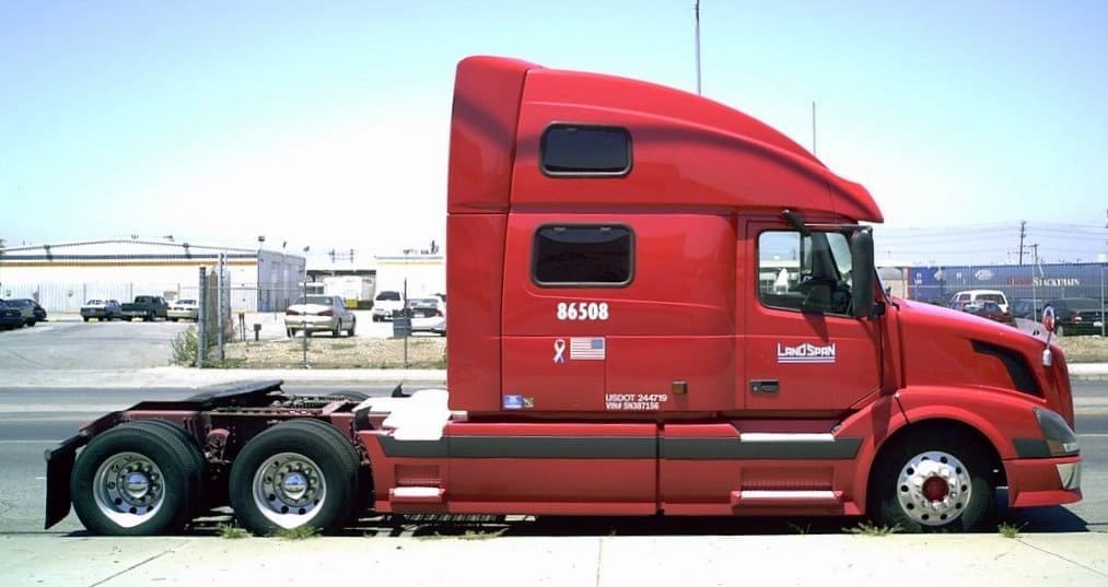 Red Color Bobtail Truck On The Road