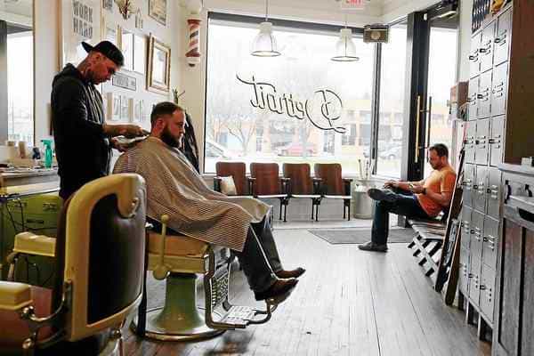 Barber Cutting Hair in Barber Shop
