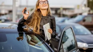 A Girl With Car Holding Keys In Her Hand